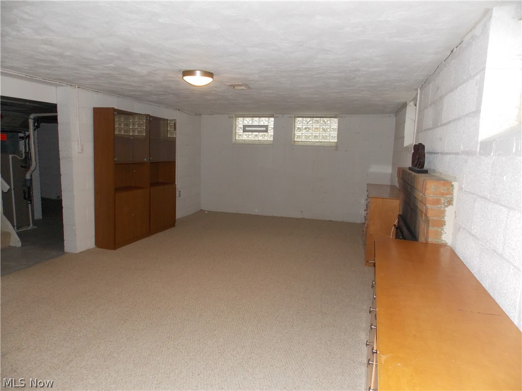 6299 South Canterbury Road Parma, OH 44129 - Photo 22 of 26 Partially finished recreation room with fireplace and glass block windows.