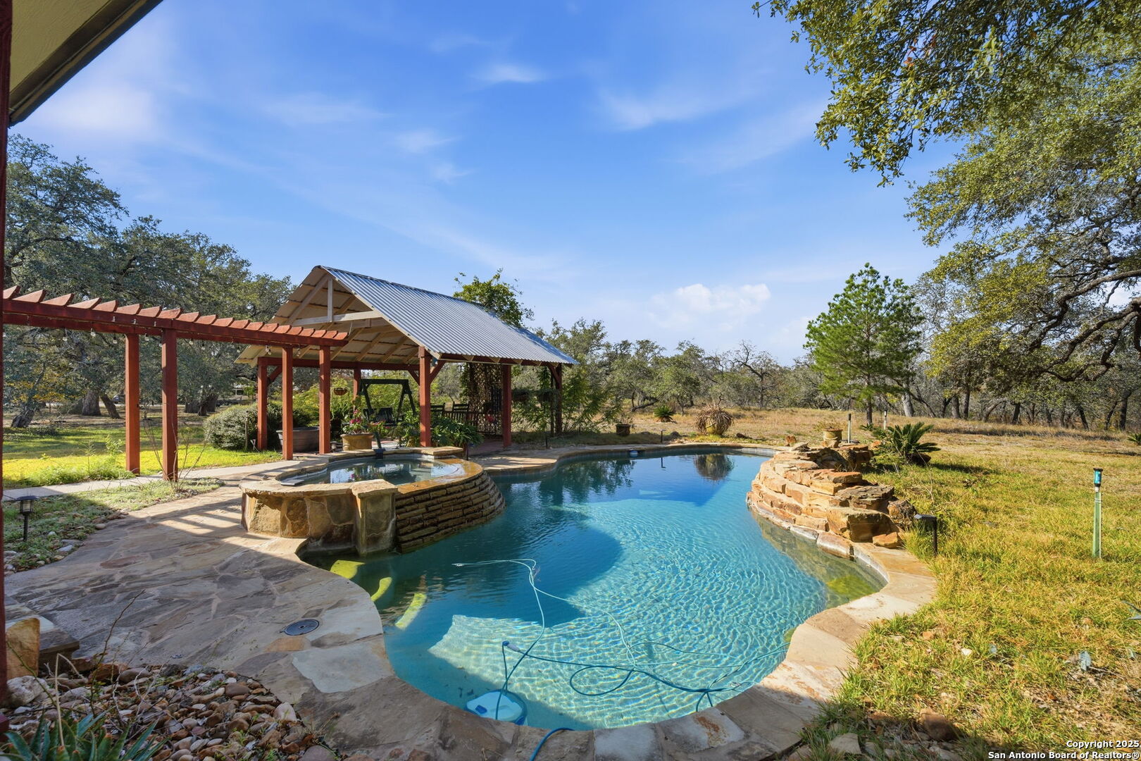 805 Paddy Road Floresville, TX 78114 - Photo 18 of 26 a view of a swimming pool with lounge chairs