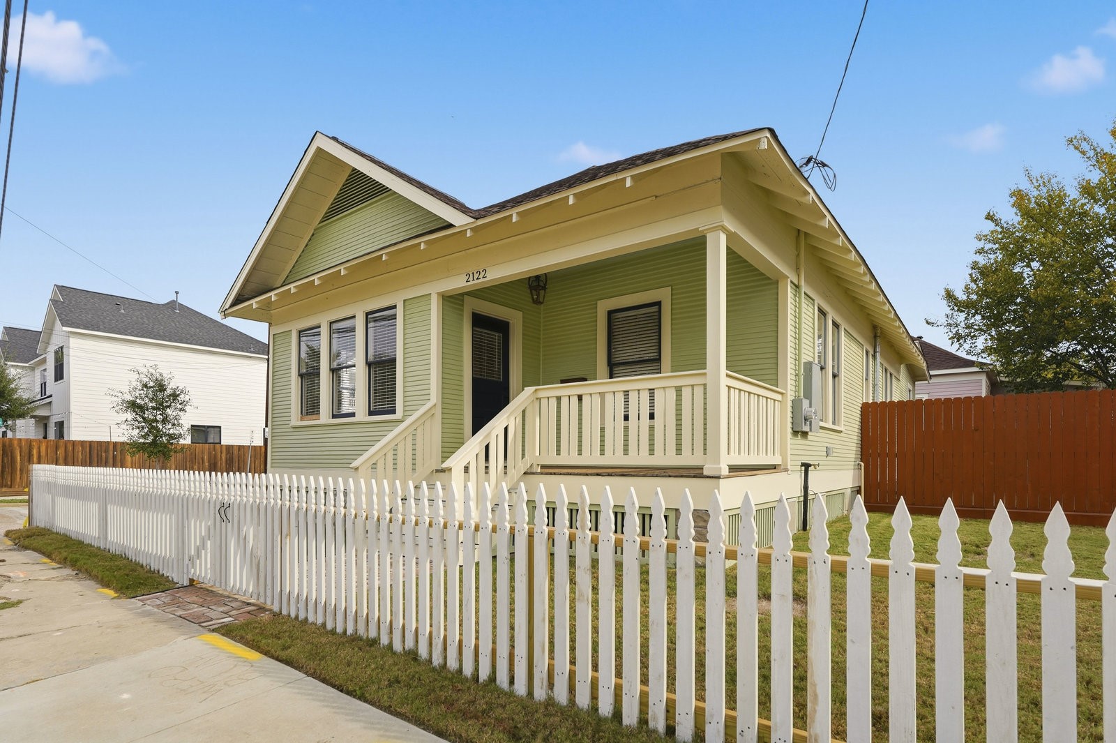 a view of a house with wooden fence