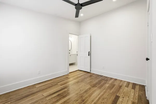 a view of a room with wooden floor