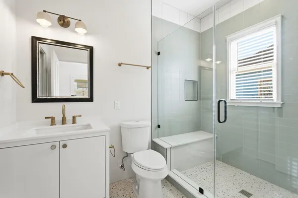 a bathroom with a toilet sink and shower