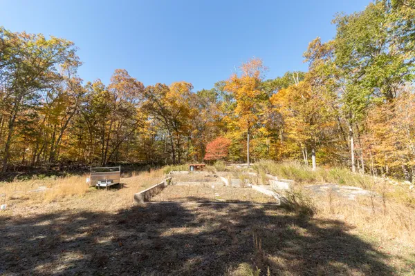 a backyard of a house with table and chairs