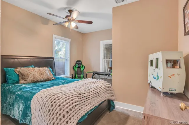 a bedroom with two beds and a chandelier