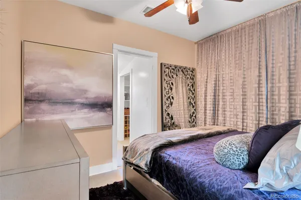 a bedroom with a bed and a painting on the wall