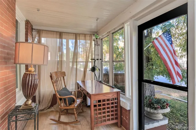 a view of a dining room with furniture water view and large windows