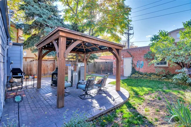 a view of a house with backyard and sitting area