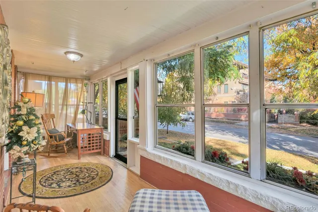a view of a livingroom with furniture and floor to ceiling window