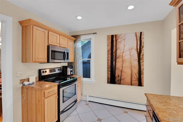 a kitchen with stainless steel appliances a refrigerator and a stove top oven