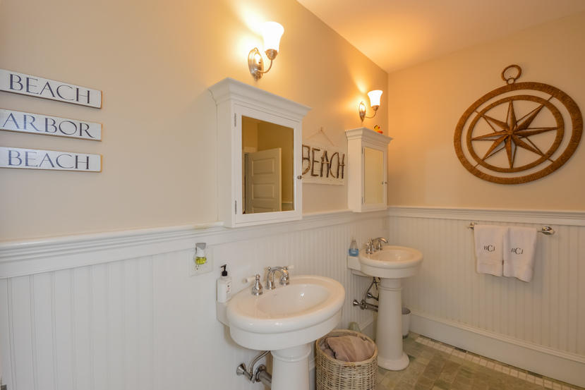 169 Tonset Road Orleans, MA 02653 - Photo 23 of 35 a bathroom with a sink a mirror and a toilet