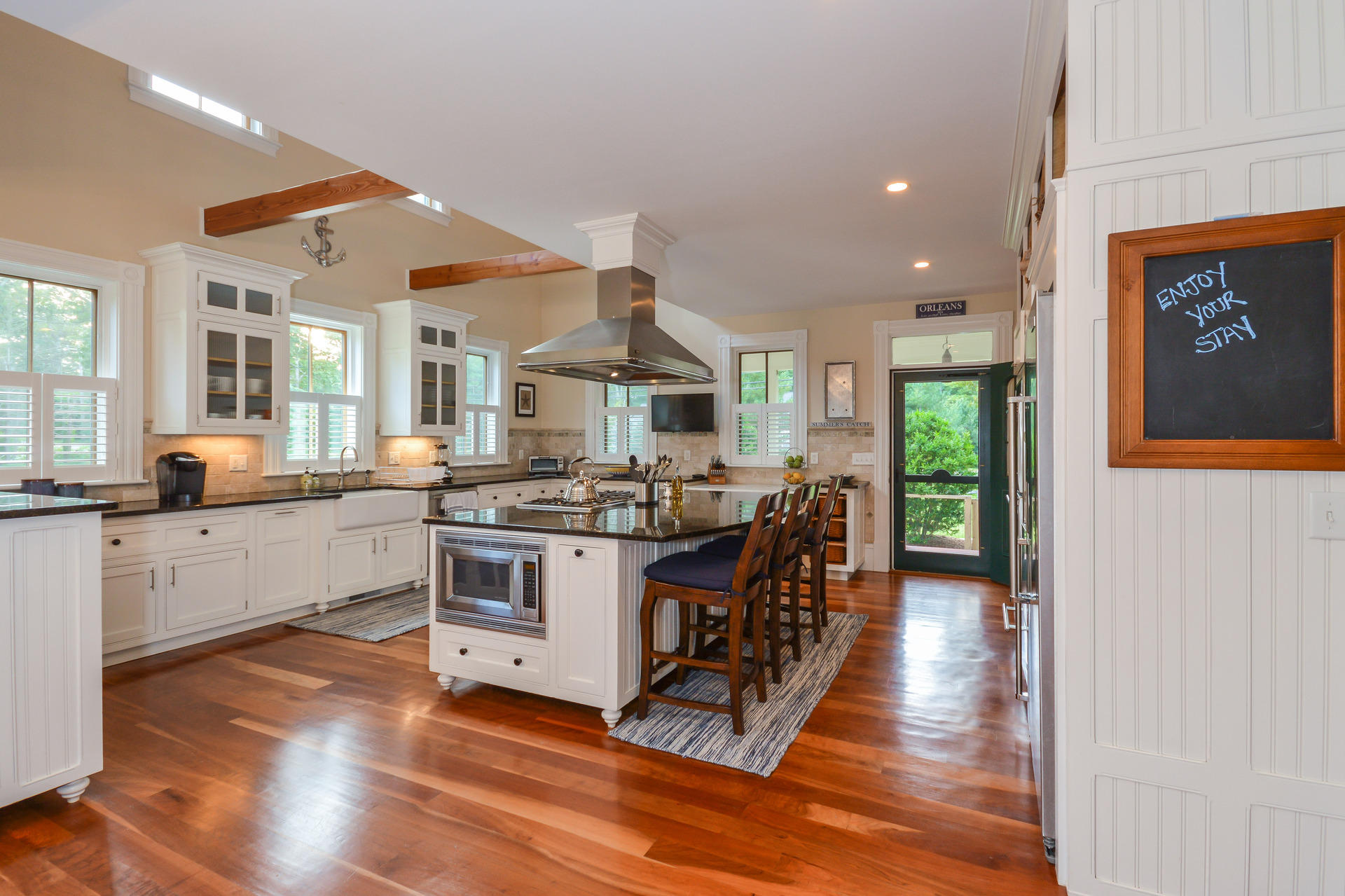 169 Tonset Road Orleans, MA 02653 - Photo 4 of 35 a large kitchen with stainless steel appliances a large counter top and a stove