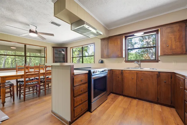 a bedroom with a bed and a flat tv screen on dresser