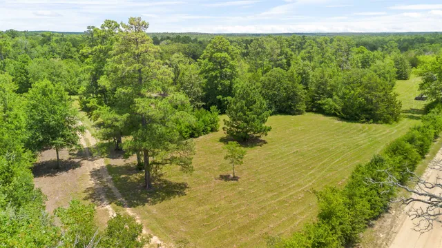 a kitchen with stainless steel appliances granite countertop a stove top oven a dining table and chairs with wooden floor