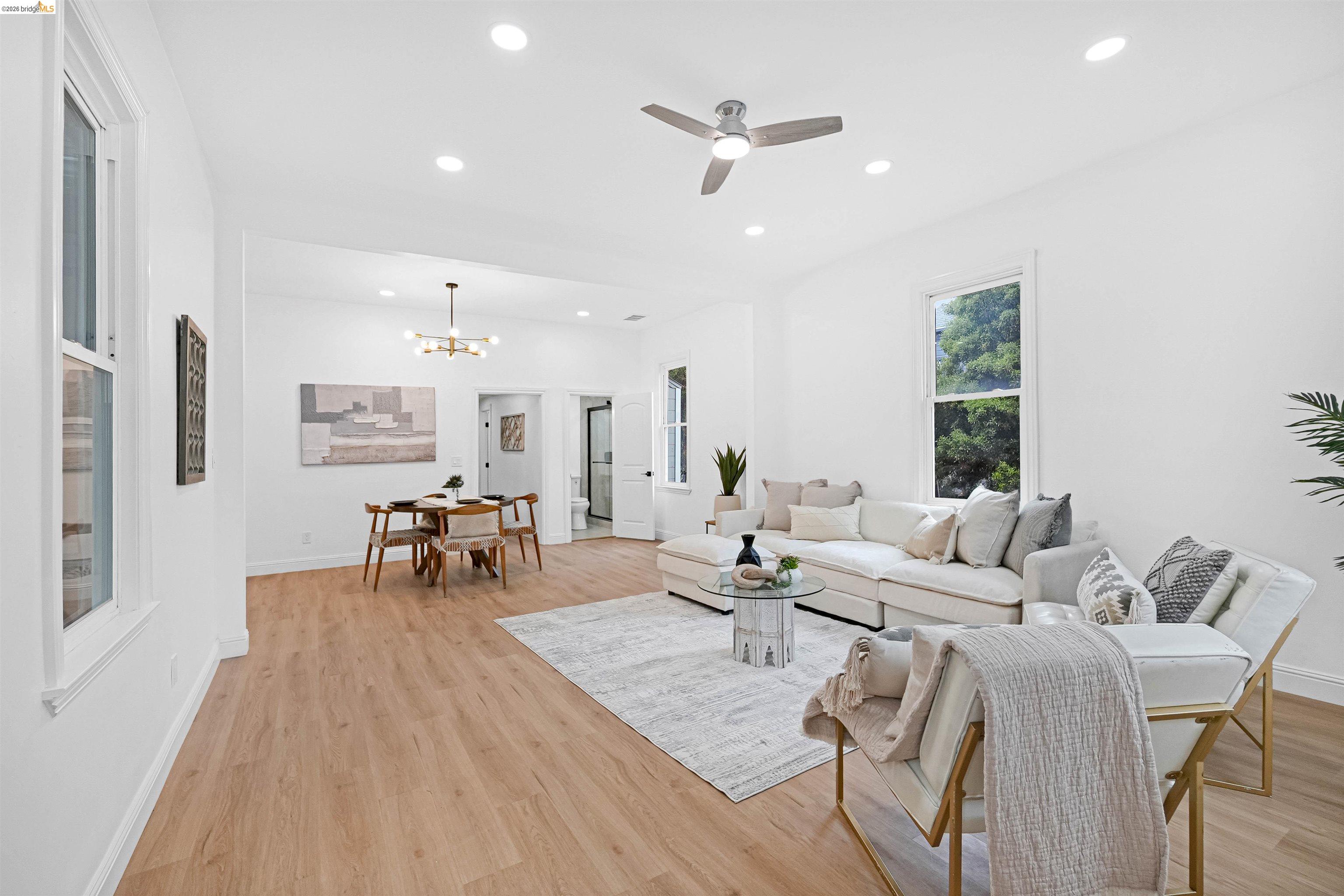 1812 Woolsey Street Berkeley, CA 94703 - Photo 5 of 48 Open-concept living and dining area featuring wood-finish flooring, recessed lighting, and white walls