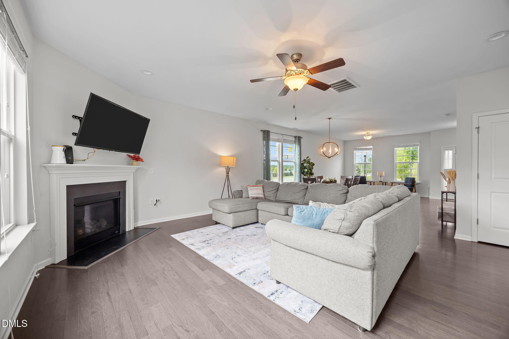 1525 Reynolds Mill Road Wake Forest, NC 27587 - Photo 12 of 40 a living room with furniture a fireplace and a flat screen tv