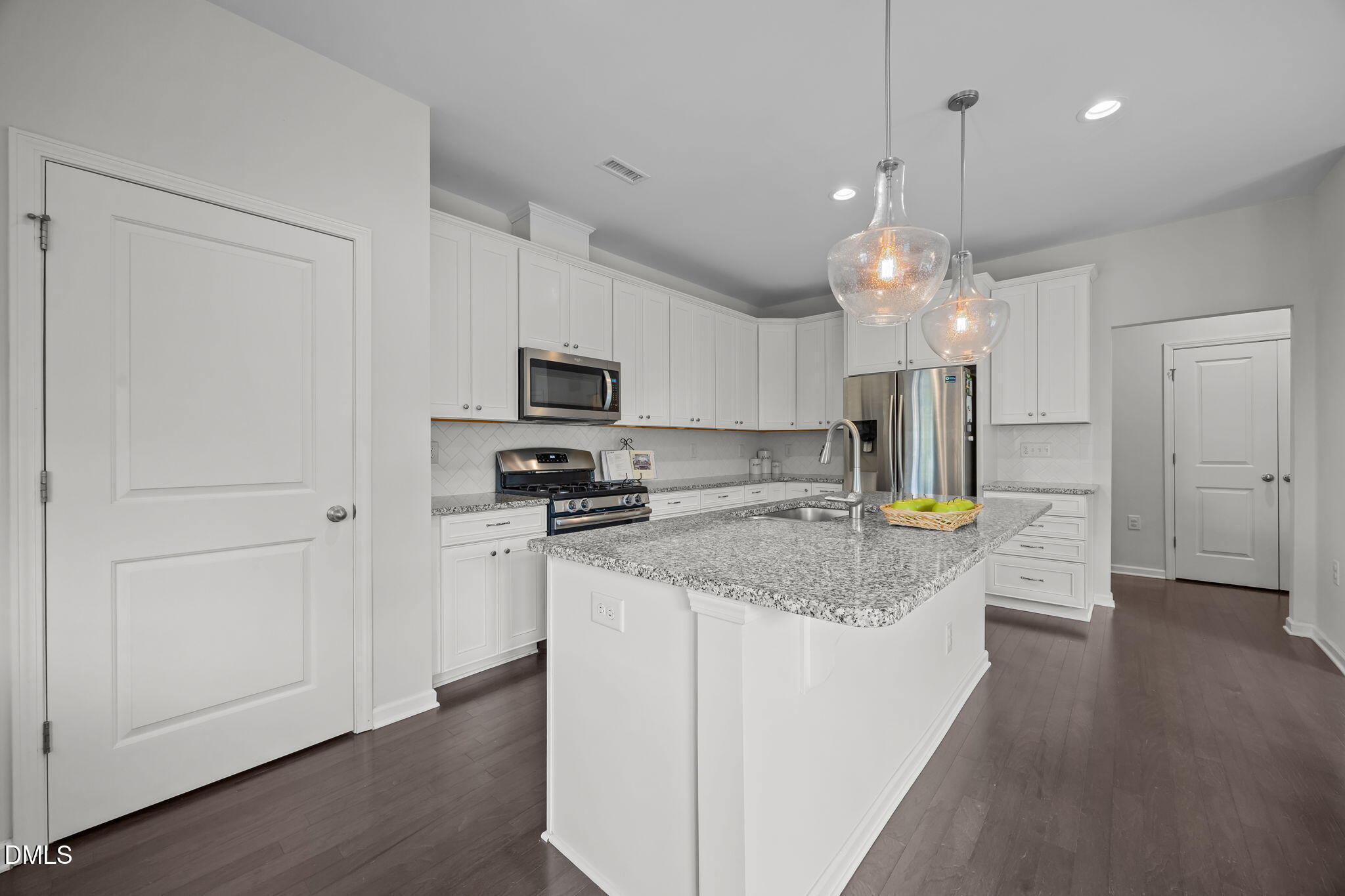 1525 Reynolds Mill Road Wake Forest, NC 27587 - Photo 15 of 40 a kitchen with kitchen island granite countertop a sink a counter top space stainless steel appliances and cabinets