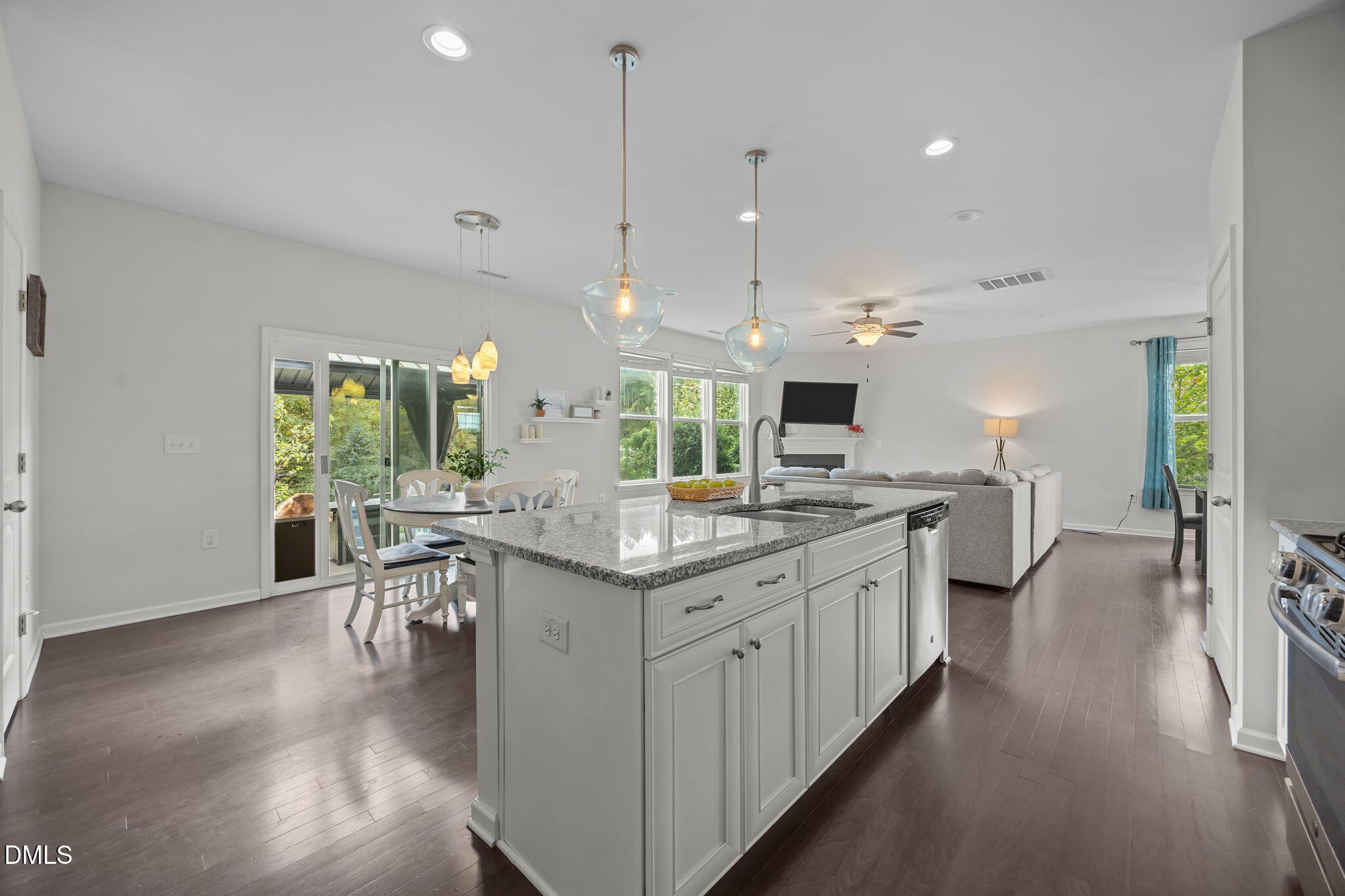 1525 Reynolds Mill Road Wake Forest, NC 27587 - Photo 17 of 40 a kitchen with lots of counter space a sink appliances and a living room view