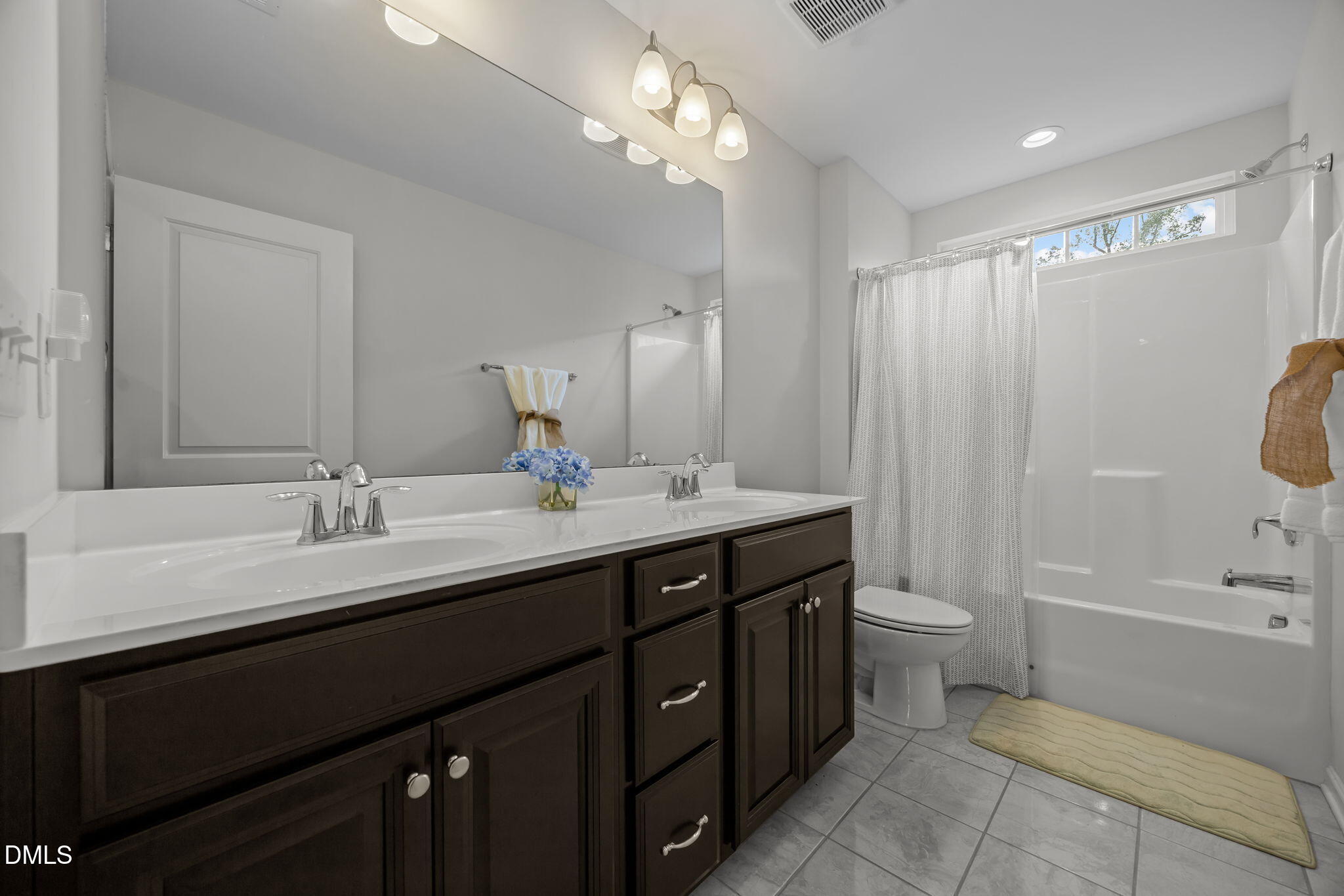 1525 Reynolds Mill Road Wake Forest, NC 27587 - Photo 23 of 40 a bathroom with a double vanity sink a toilet and a mirror