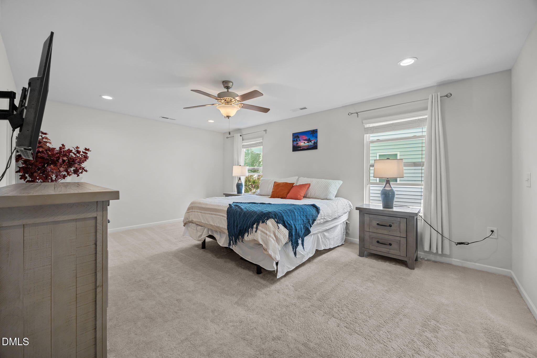 1525 Reynolds Mill Road Wake Forest, NC 27587 - Photo 25 of 40 a bedroom with a bed and a chandelier