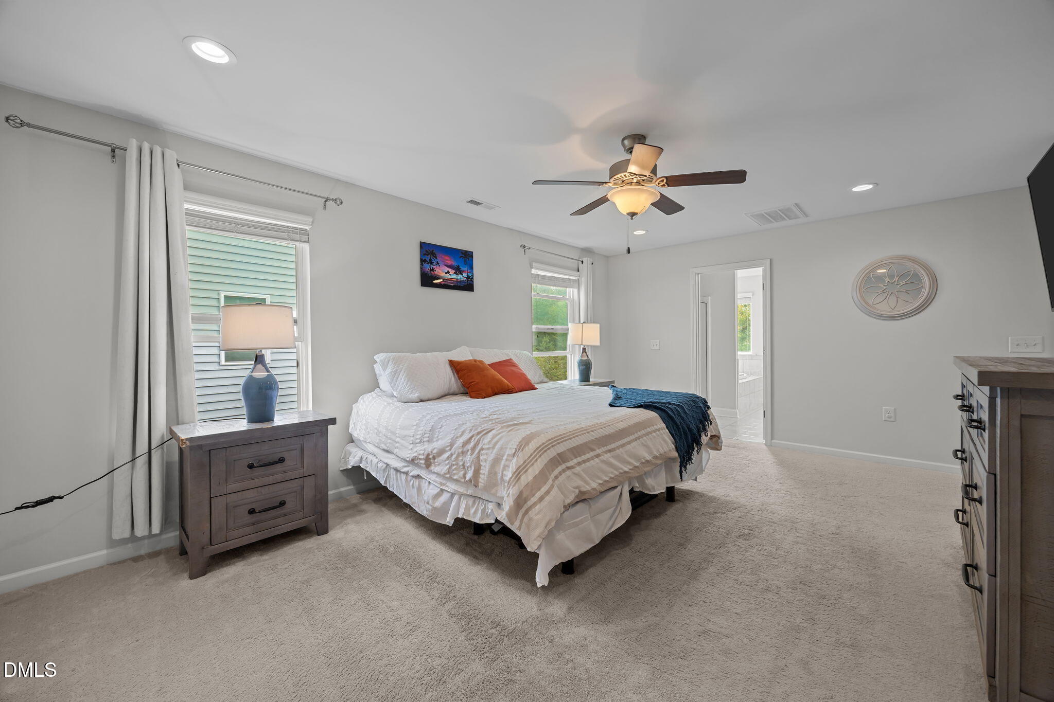 1525 Reynolds Mill Road Wake Forest, NC 27587 - Photo 26 of 40 a bedroom with a bed and a chandelier