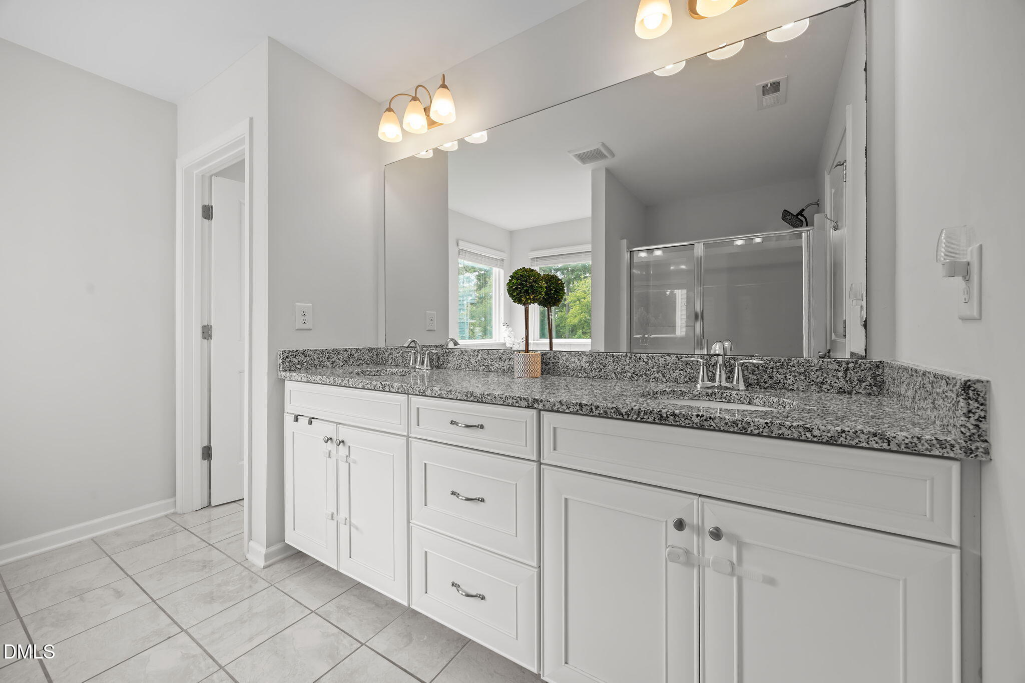 1525 Reynolds Mill Road Wake Forest, NC 27587 - Photo 29 of 40 a bathroom with a granite countertop double sink and a mirror