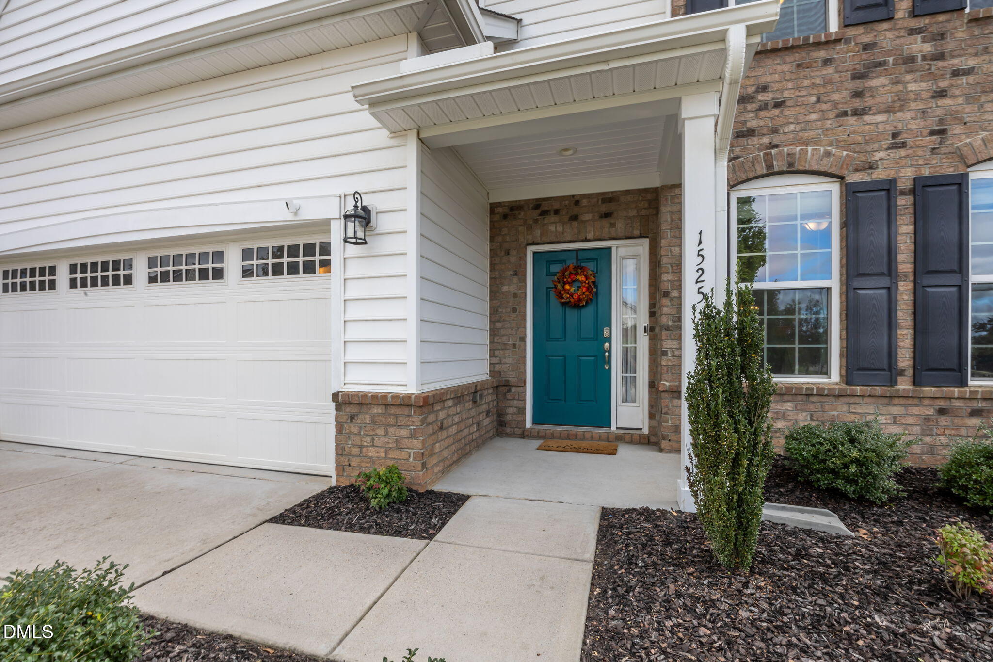 1525 Reynolds Mill Road Wake Forest, NC 27587 - Photo 2 of 40 a front view of a house with garden
