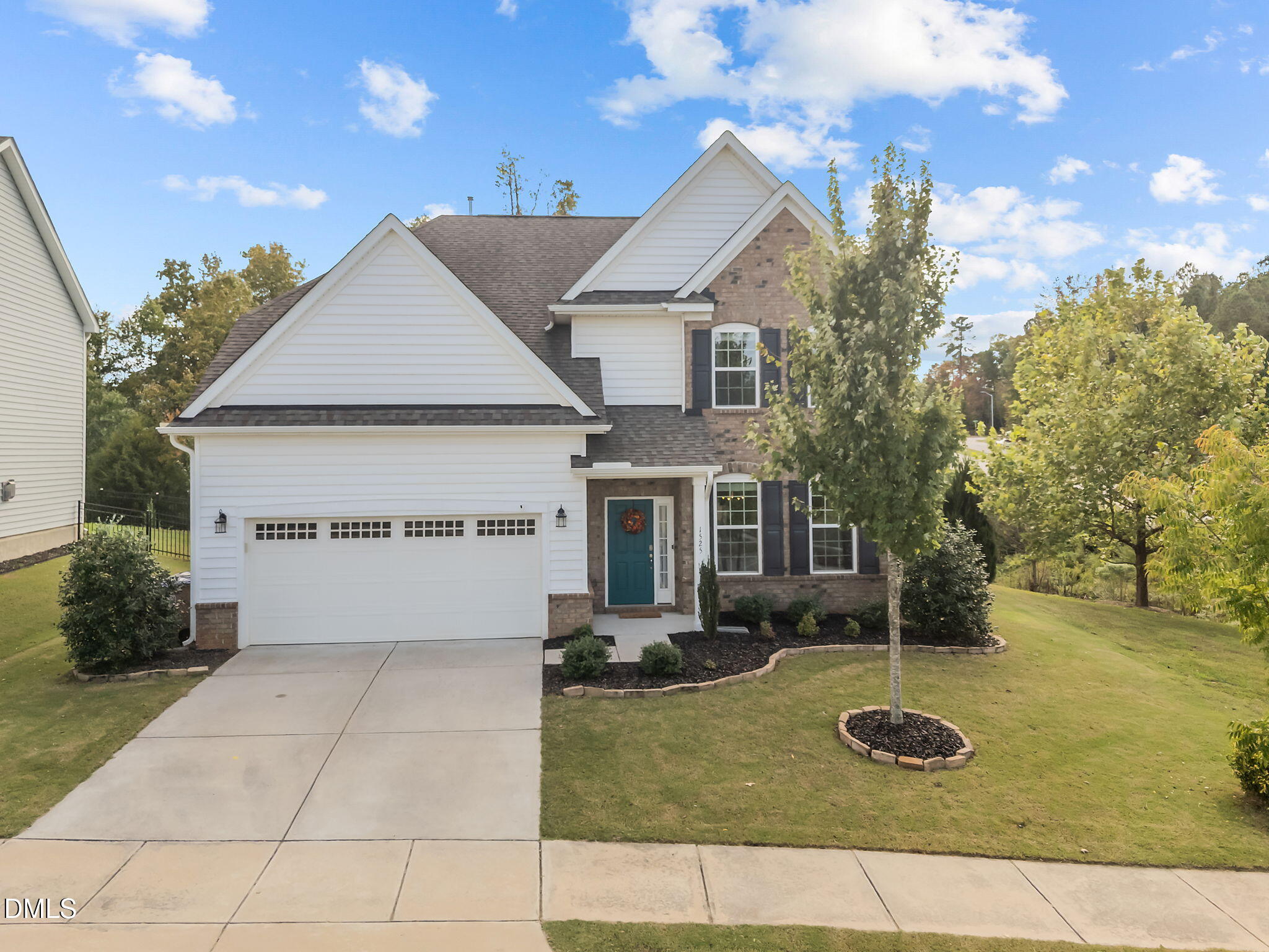 1525 Reynolds Mill Road Wake Forest, NC 27587 - Photo 4 of 40 a front view of a house with garden