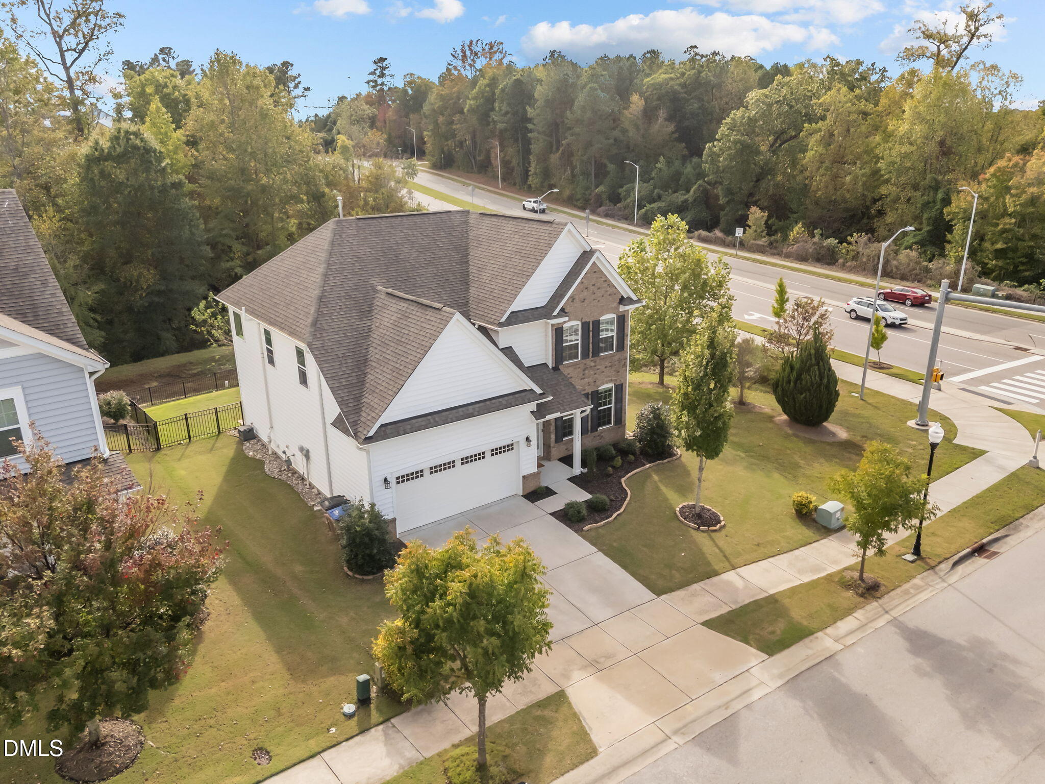 1525 Reynolds Mill Road Wake Forest, NC 27587 - Photo 6 of 40 a view of a white house with a yard and potted plants