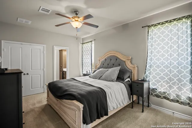 a bedroom with a bed and cabinets