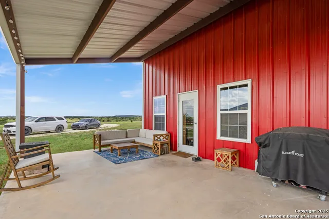 a bedroom with a bed a couch and next to a window