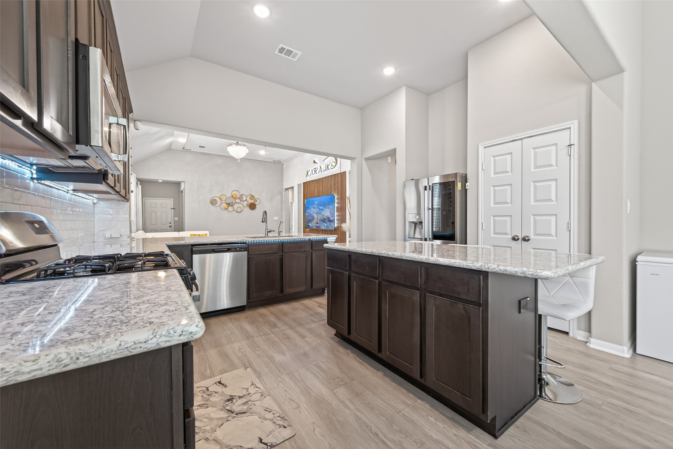 22409 Kinley Street New Caney, TX 77357 - Photo 21 of 46 a large kitchen with stainless steel appliances granite countertop a large counter top and a stove