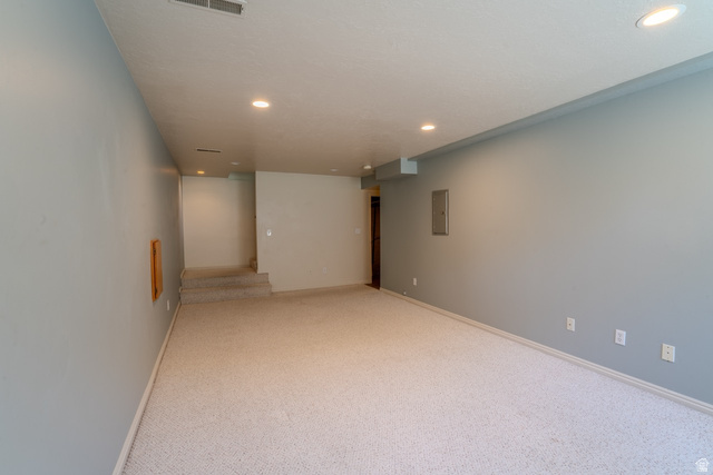 11957 Noelle Road Sandy, UT 84092 - Photo 23 of 38 Spacious room featuring light-colored carpet, recessed lighting, and pale blue walls