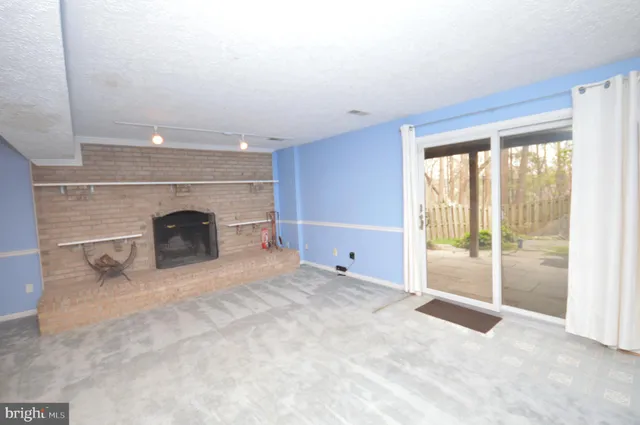 a view of empty room with a fireplace