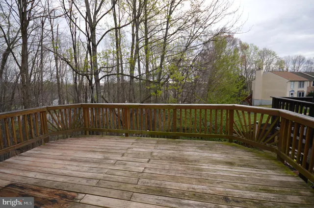 a view of balcony with wooden floor and fence