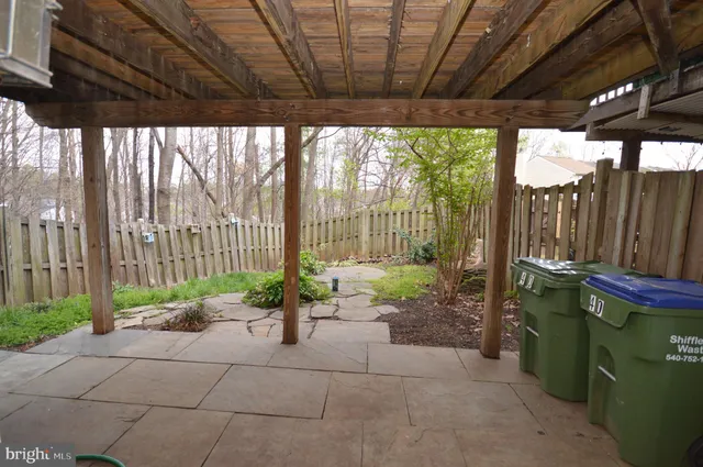 a backyard of a house with chairs and a table