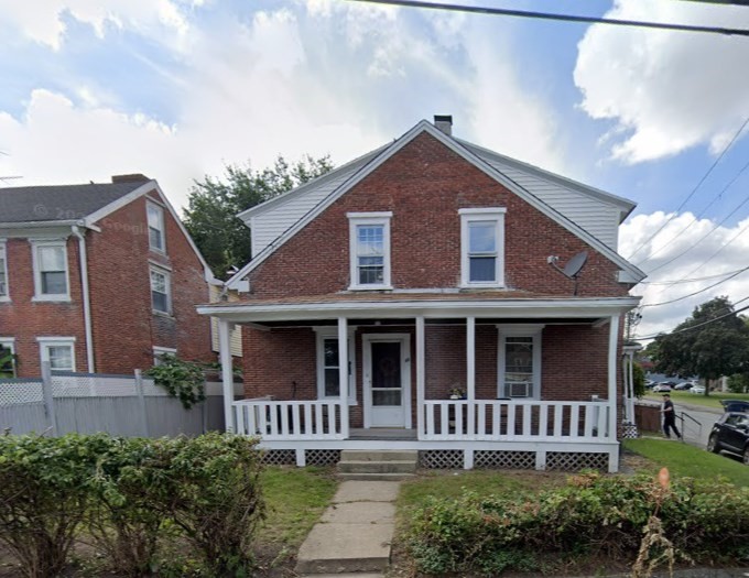 a front view of a house with garden