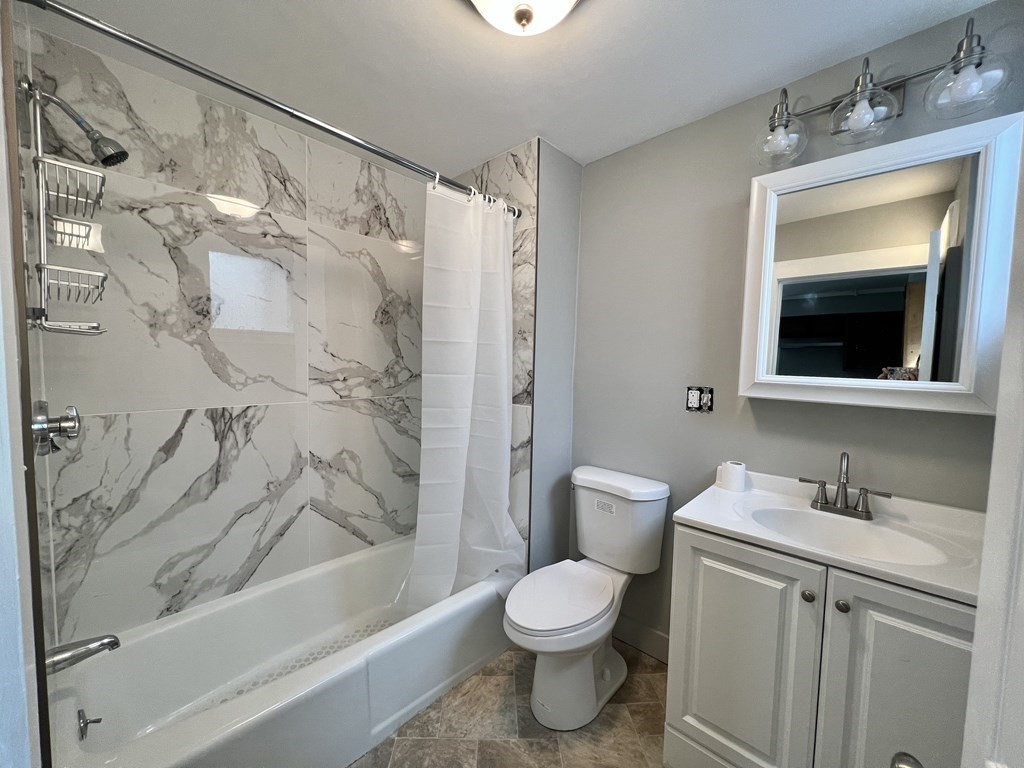 68 Bemis Road, Unit 1 Fitchburg, MA 01420 - Photo 3 of 10 a bathroom with a toilet sink and shower