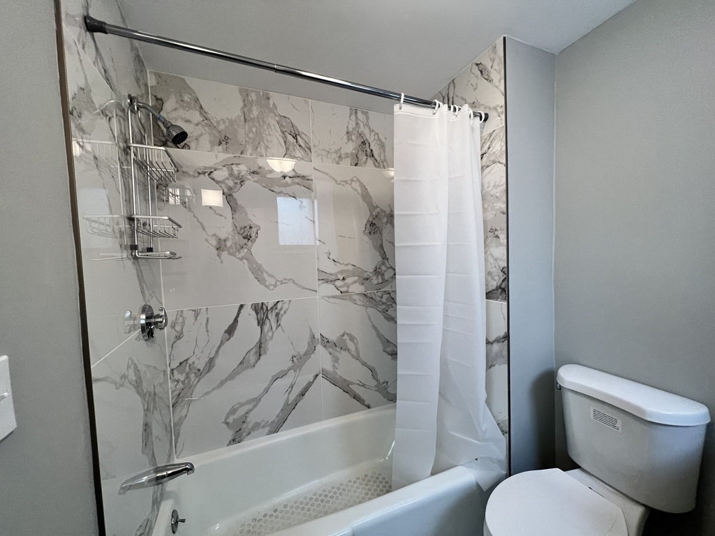 68 Bemis Road, Unit 1 Fitchburg, MA 01420 - Photo 4 of 10 a bathroom with a shower and a toilet