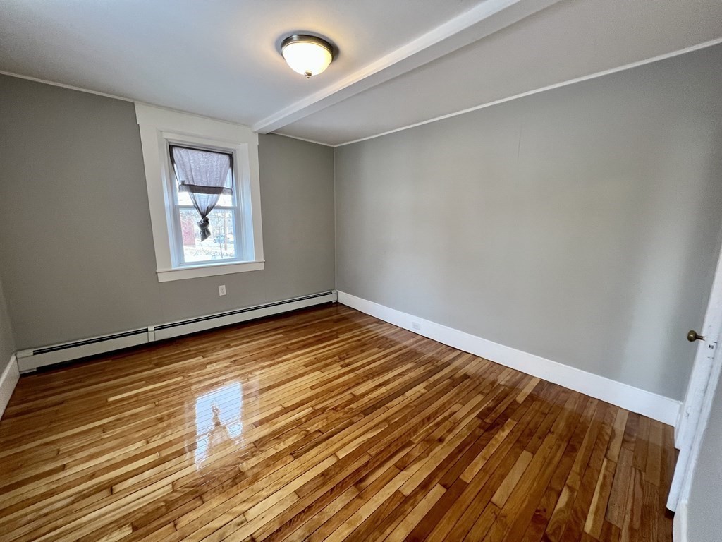 68 Bemis Road, Unit 1 Fitchburg, MA 01420 - Photo 6 of 10 a view of empty room with wooden floor and fan
