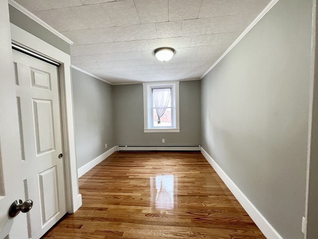 68 Bemis Road, Unit 1 Fitchburg, MA 01420 - Photo 7 of 10 a view of a room with window and wooden floor