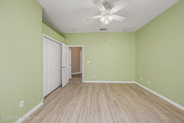a spacious bathroom with a granite countertop sink a mirror a vanity and bathtub