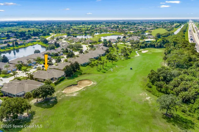 an aerial view of a house with outdoor space and street view