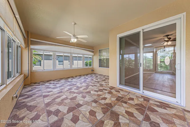 a bathroom with a granite countertop sink a toilet a mirror and shower