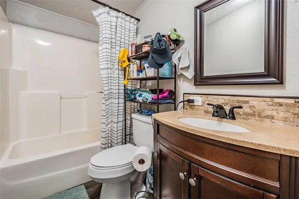 a bathroom with a sink vanity mirror and toilet