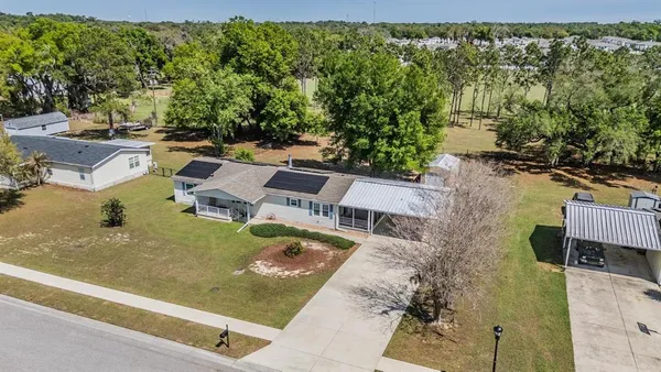 an aerial view of a house with a yard