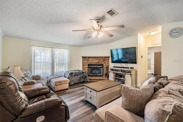a living room with furniture flat screen tv and a fireplace