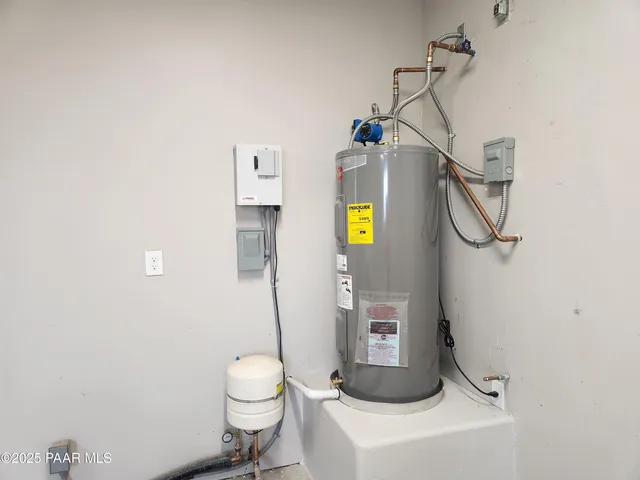 a bathroom with a granite countertop toilet and a sink