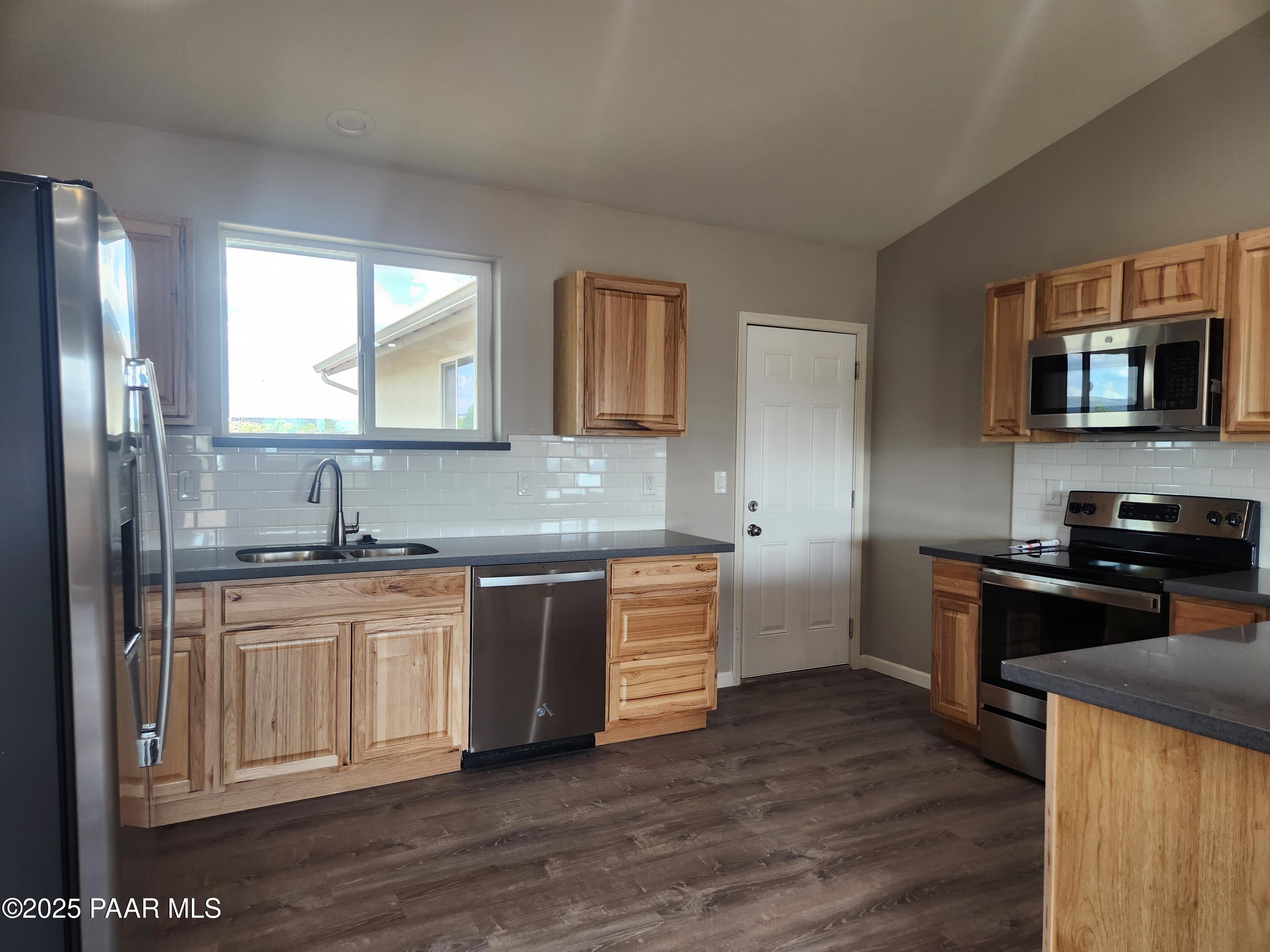 895 Ranch House Road Paulden, AZ 86334 - Photo 3 of 21 a kitchen with granite countertop a stove top oven sink and cabinets
