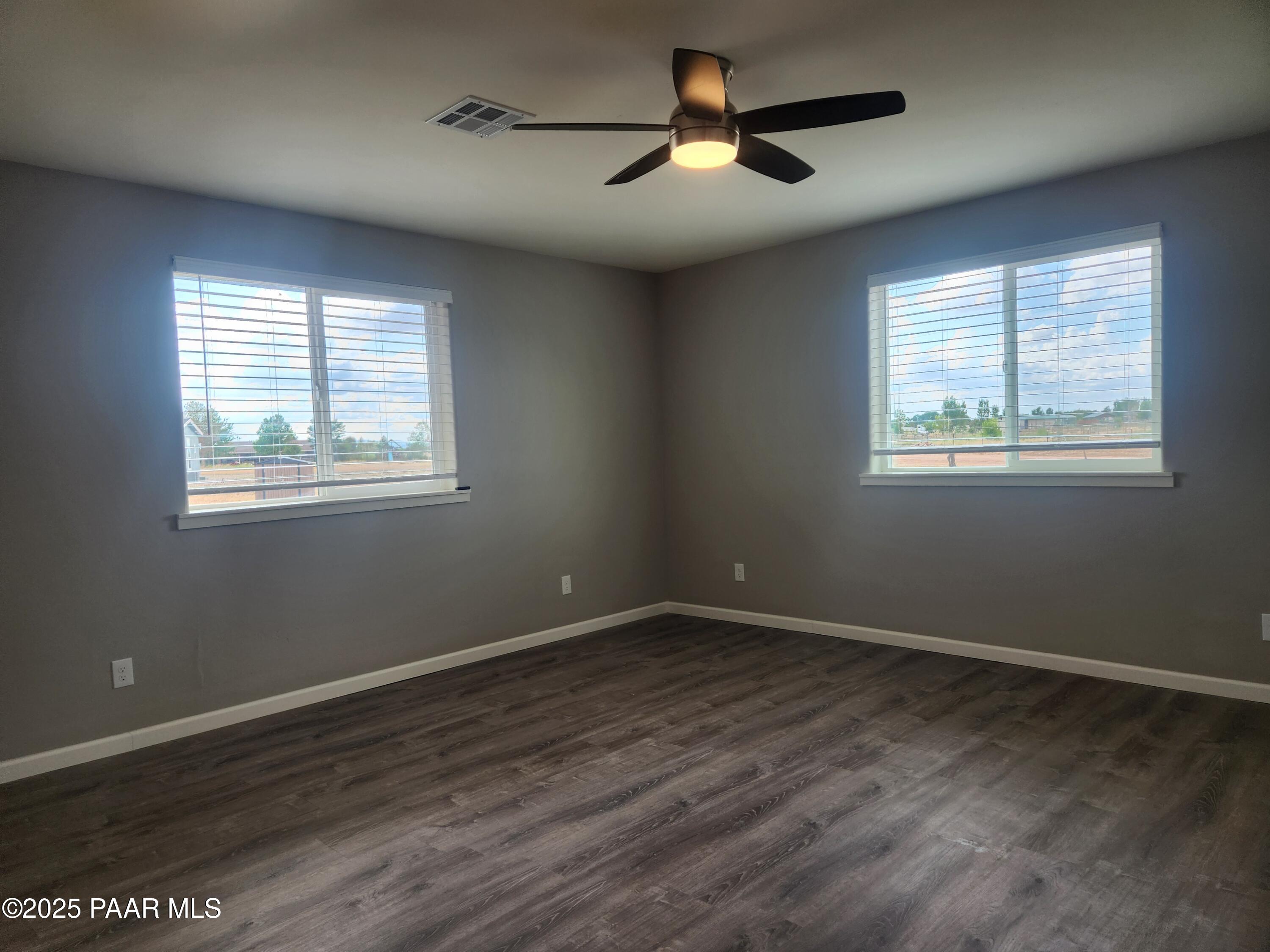 895 Ranch House Road Paulden, AZ 86334 - Photo 5 of 21 a view of empty room with wooden floor and fan