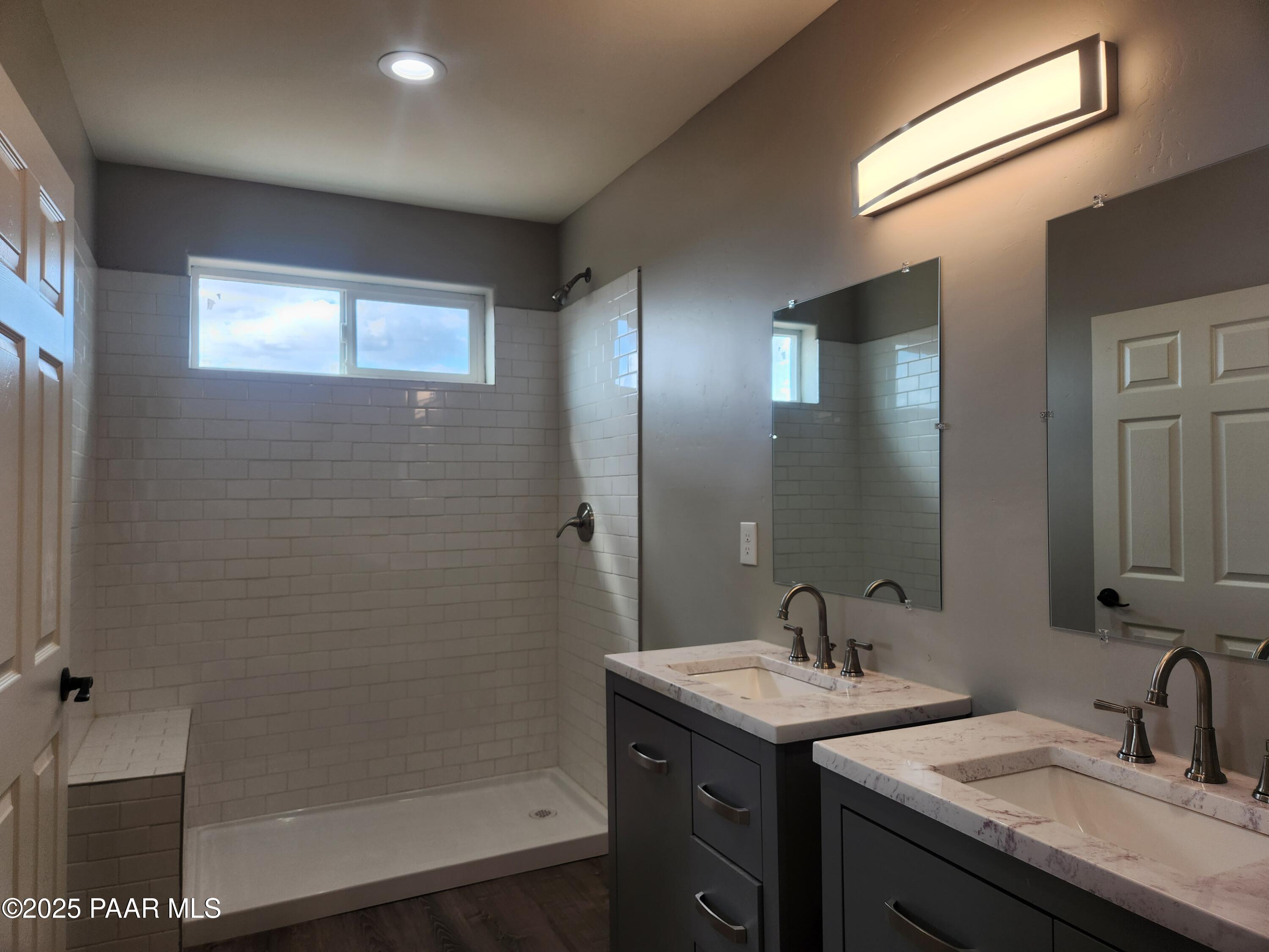895 Ranch House Road Paulden, AZ 86334 - Photo 7 of 21 a bathroom with a granite countertop sink a mirror and a shower