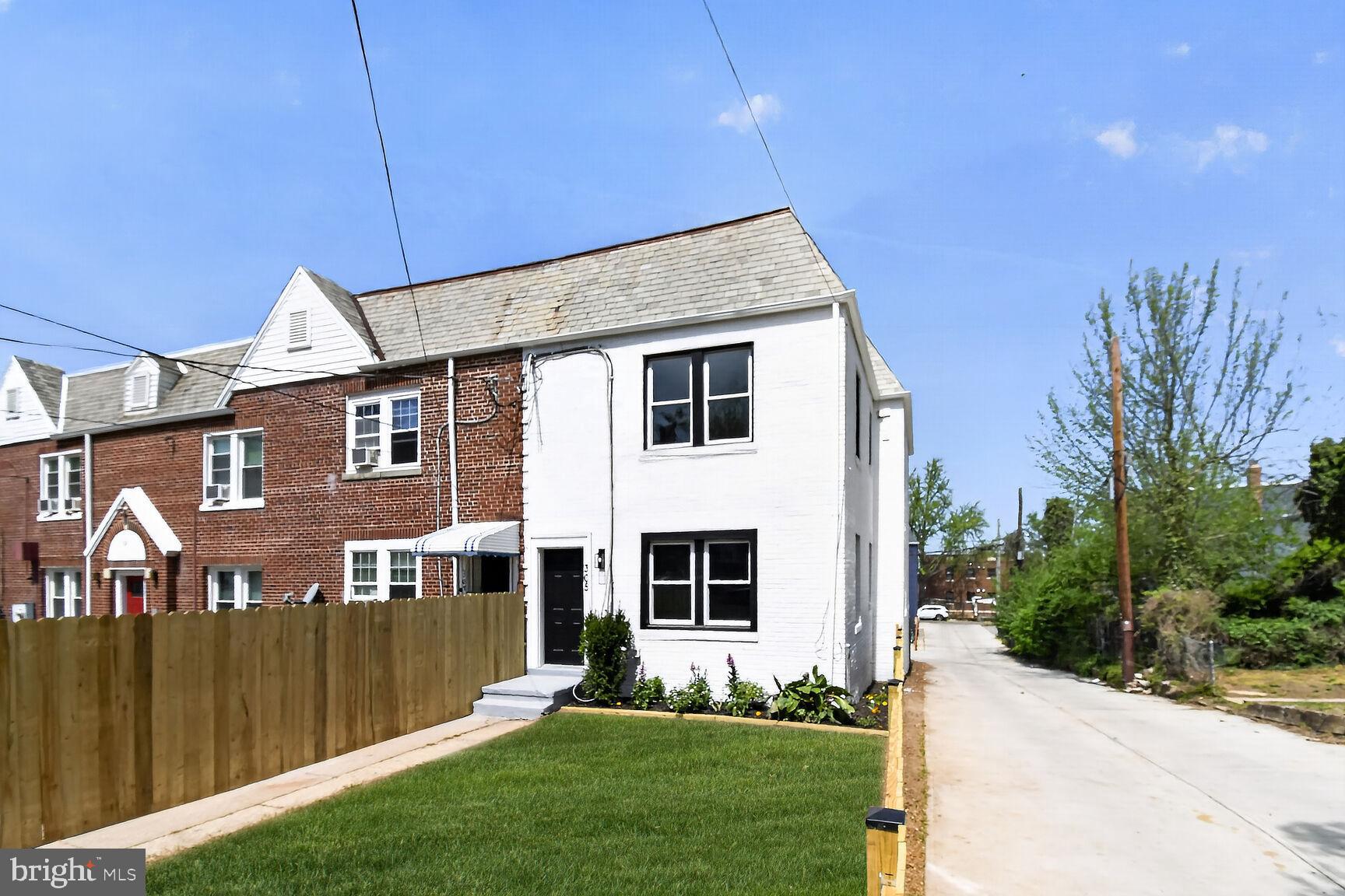305 Decatur Street Northwest Washington, DC 20011 - Photo 1 of 21 a front view of a house with a yard